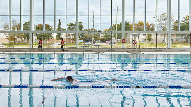 Person swimming laps in the indoor lap pool at the Bostwick YMCA in London, Ontario
